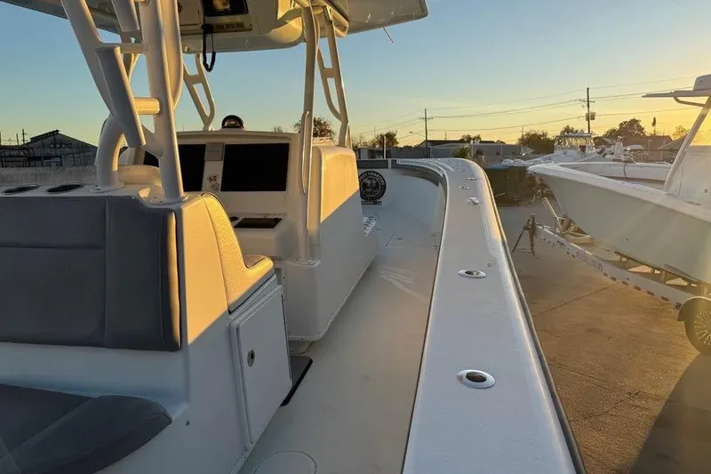 Slide: The Image of 2015 Yellowfin 39 Offshore boat interior at sunset, showcasing helm and seating area. - 4