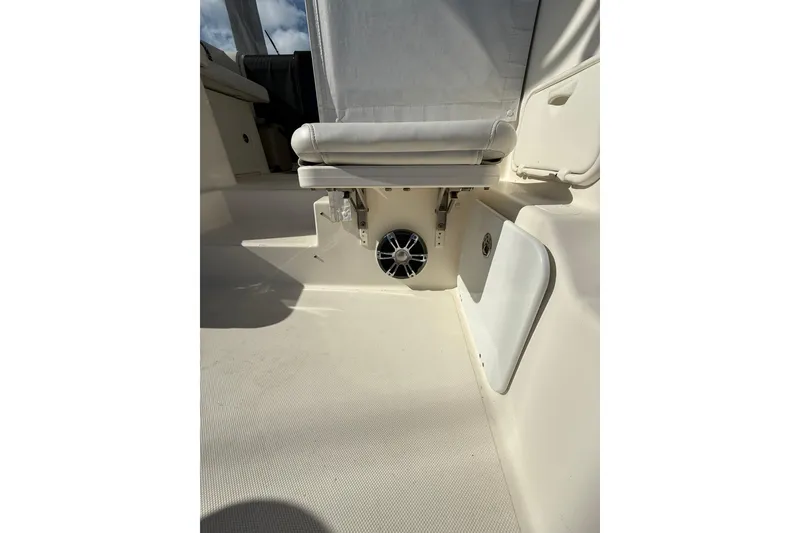 Slide: The Image of 2004 Pursuit 3370 Offshore boat interior with seating and speaker detail. - 22