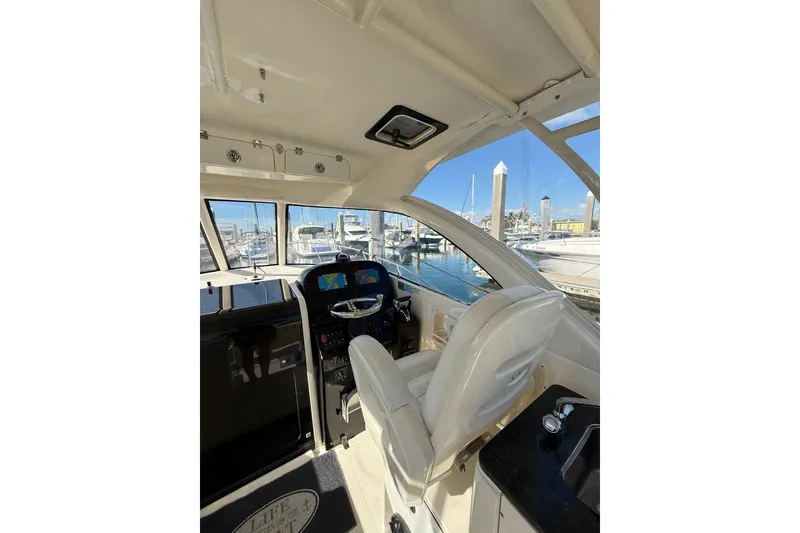 Slide: The Image of Interior view of 2004 Pursuit 3370 Offshore boat cockpit with marina background. - 29