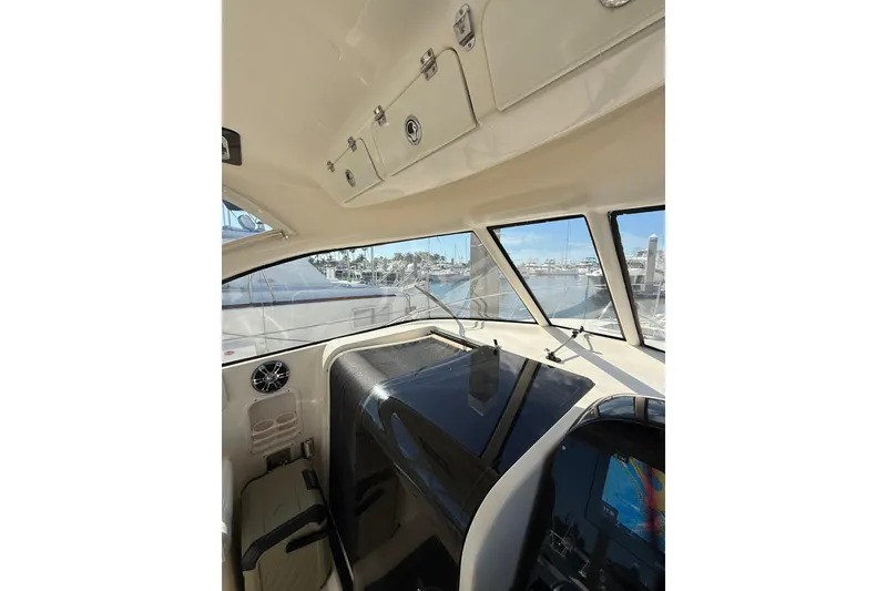 Slide: The Image of 2004 Pursuit 3370 Offshore boat interior with marina view through windows. - 34