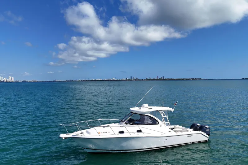 Slide: The Image of 2004 Pursuit 3370 Offshore boat on calm blue water under a clear sky. - 5