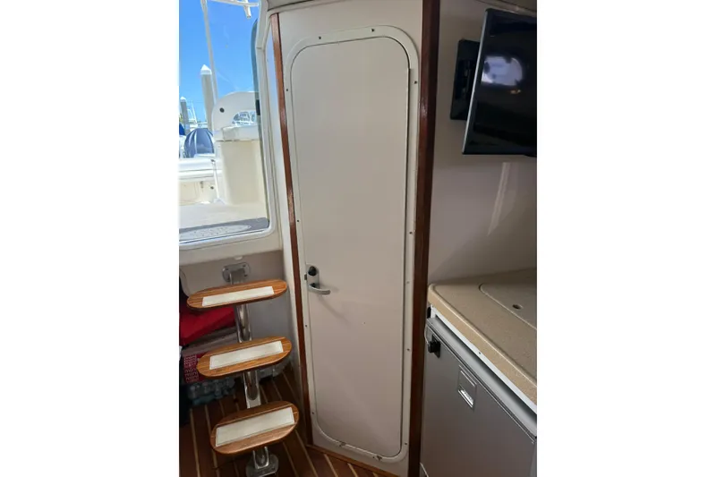 Slide: The Image of Interior of 2004 Pursuit 3370 Offshore boat with steps and cabin door. - 51