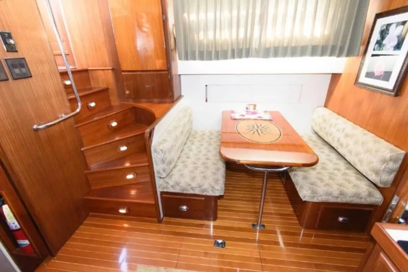 Slide: The Image of 1988 Hatteras 54 Motor Yacht kitchen with wooden cabinets, modern appliances, and a cozy rug. - 13