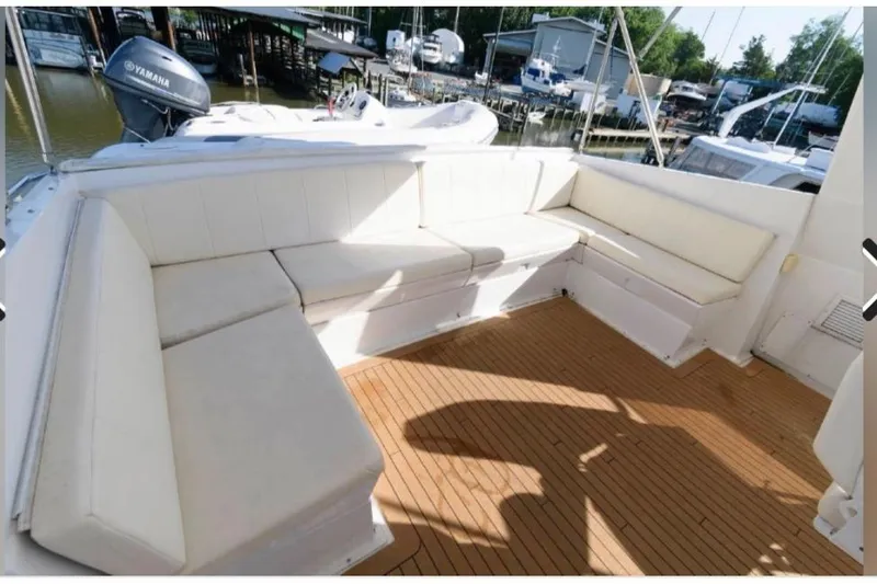 Slide: The Image of 1988 Hatteras 54 Motor Yacht with spacious outdoor seating and teak deck. - 18