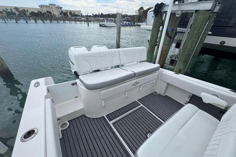Slide: The Image of 2018 Fountain 34 Center Console boat docked, featuring spacious seating and sleek design. - 10