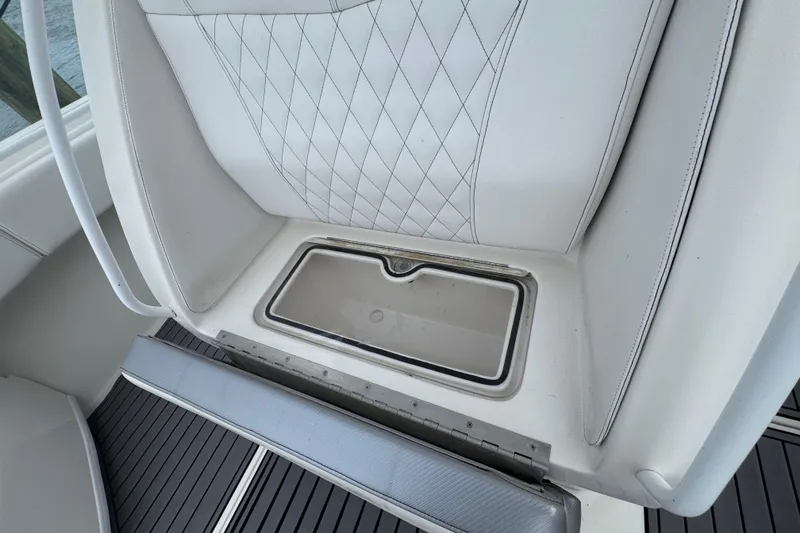Slide: The Image of 2018 Fountain 34 Center Console seat with storage compartment, featuring diamond-stitched upholstery. - 12