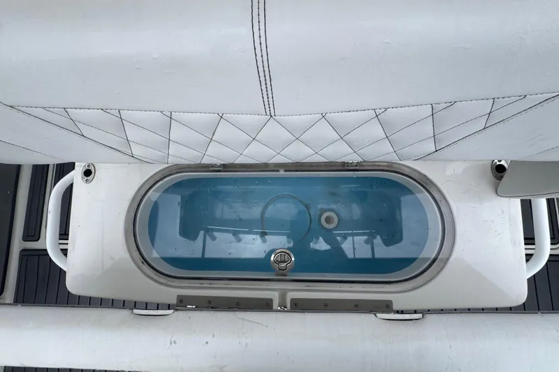 Slide: The Image of 2018 Fountain 34 Center Console livewell with cushioned seating and sleek design. - 13