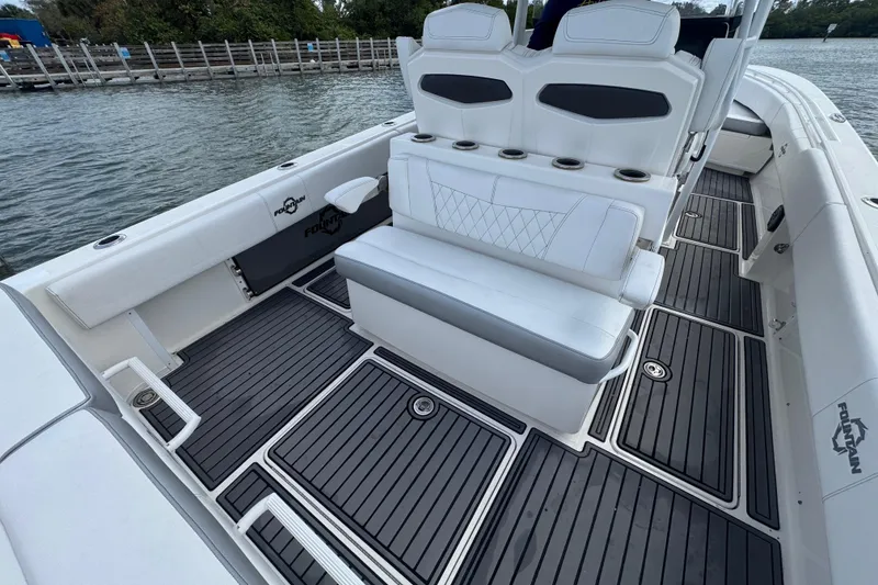 Slide: The Image of 2018 Fountain 34 Center Console boat interior with white seating and sleek flooring. - 15