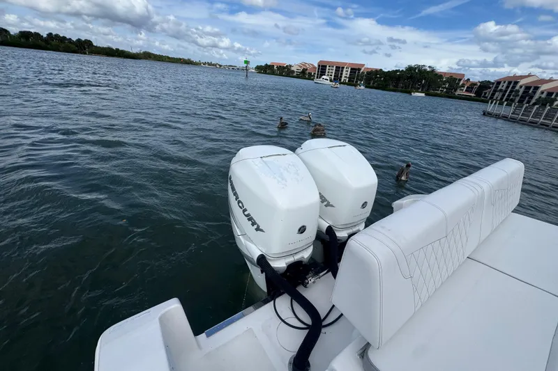 Slide: The Image of 2018 Fountain 34 Center Console boat with twin Mercury engines on a calm waterway. - 17