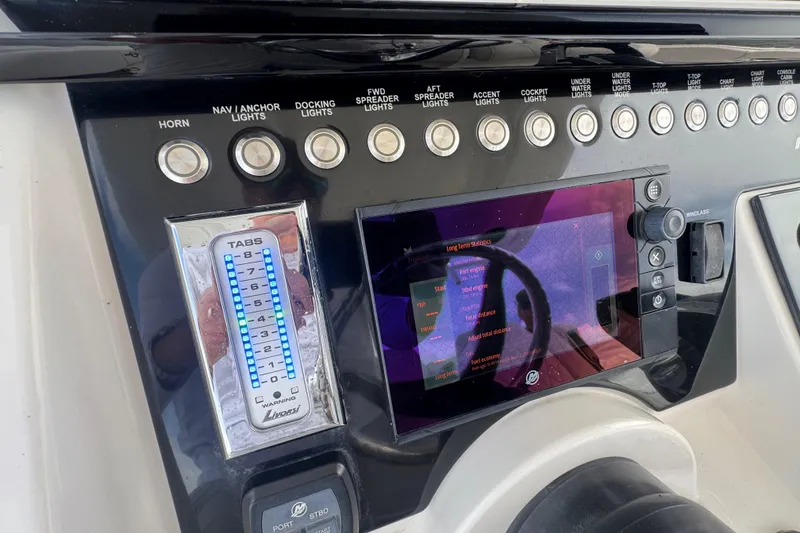 Slide: The Image of Control panel of a 2018 Fountain 34 Center Console boat with navigation and lighting controls. - 19
