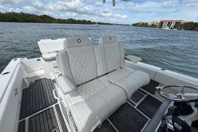 Slide: The Image of 2018 Fountain 34 Center Console boat with luxurious white seating on calm water. - 21