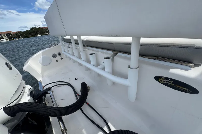 Slide: The Image of 2018 Fountain 34 Center Console boat interior with rod holders and marine equipment. - 22