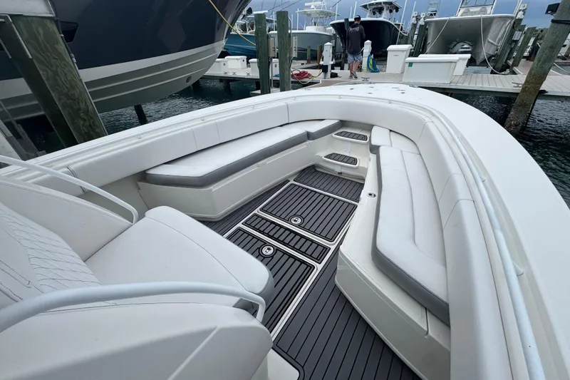 Slide: The Image of 2018 Fountain 34 Center Console boat with spacious seating at a marina dock. - 5