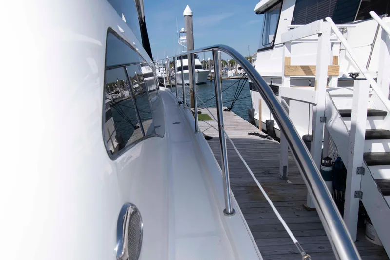Slide: The Image of 2013 Meridian 441 Sedan yacht docked at marina, showcasing sleek design and polished railings. - 14