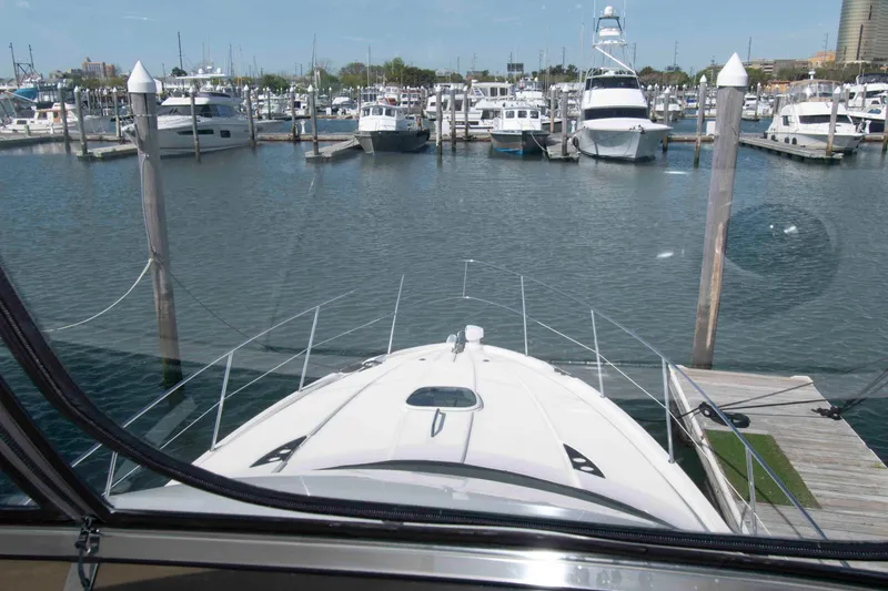 Slide: The Image of View from a 2013 Meridian 441 Sedan yacht docked at a marina with multiple boats. - 15
