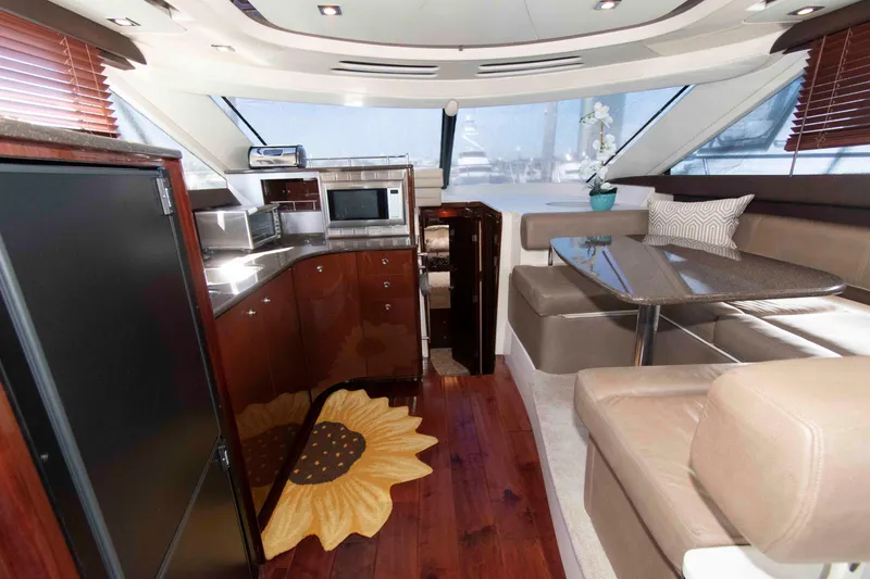 Slide: The Image of Luxurious interior of 2013 Meridian 441 Sedan yacht with modern kitchen and dining area. - 19