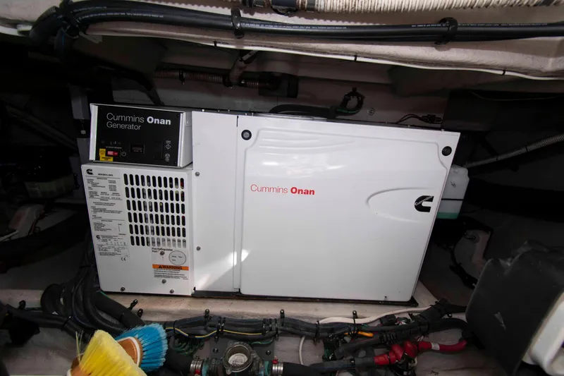 Slide: The Image of Cummins Onan generator in 2013 Meridian 441 Sedan engine room, surrounded by cables and equipment. - 31
