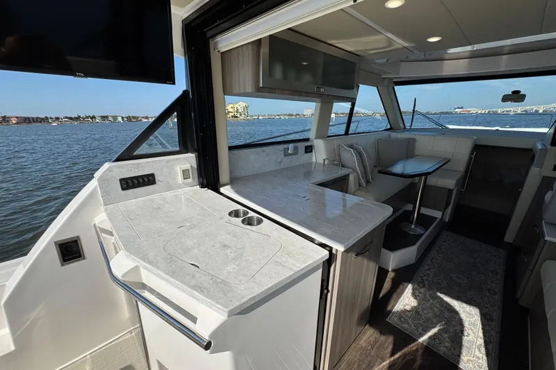 Slide: The Image of Luxurious interior of 2021 Regal 38 XO yacht with modern kitchen and seating area. - 18