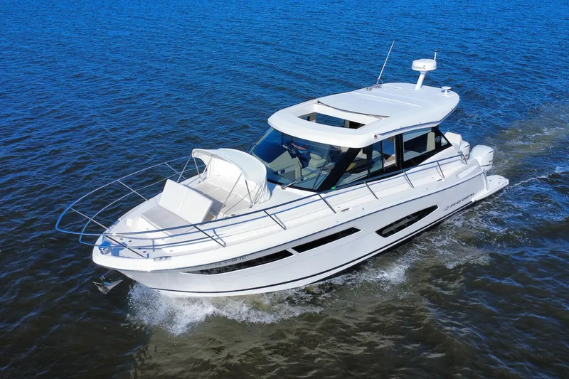 Slide: The Image of 2021 Regal 38 XO yacht cruising on open water, showcasing sleek design and luxury features. - 2