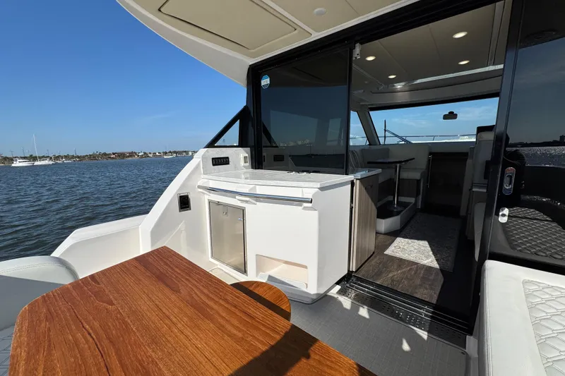 Slide: The Image of 2021 Regal 38 XO yacht interior with open deck and seating area on the water. - 22