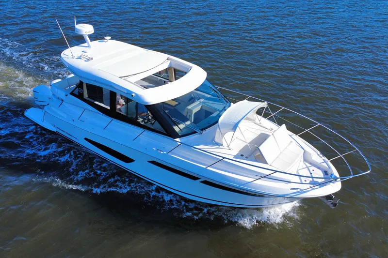 Slide: The Image of 2021 Regal 38 XO yacht cruising on open water, showcasing sleek design and luxury features. - 3