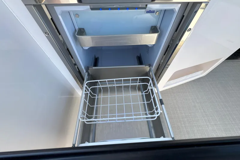 Slide: The Image of Open refrigerator drawer in 2021 Regal 38 XO yacht, showcasing storage space. - 30