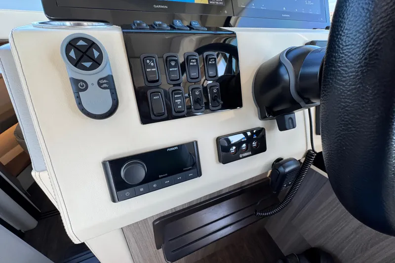 Slide: The Image of Control panel of 2021 Regal 38 XO boat with various switches and devices. - 36