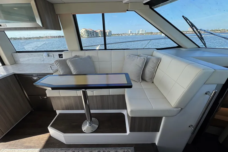 Slide: The Image of Luxurious interior of 2021 Regal 38 XO yacht with elegant seating and scenic water view. - 39