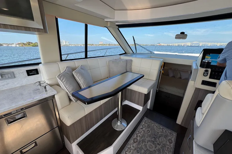 Slide: The Image of Interior of 2021 Regal 38 XO yacht with seating, table, and scenic water view. - 40