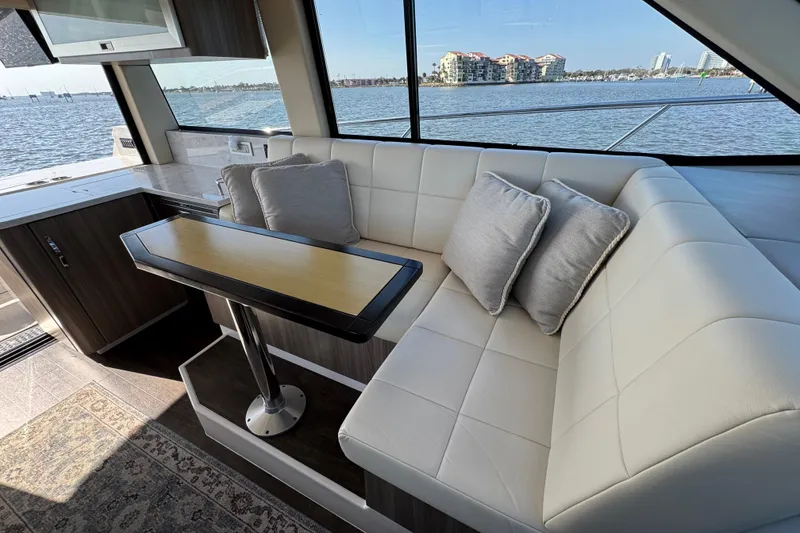 Slide: The Image of Luxurious interior of 2021 Regal 38 XO yacht with white seating and scenic water view. - 41