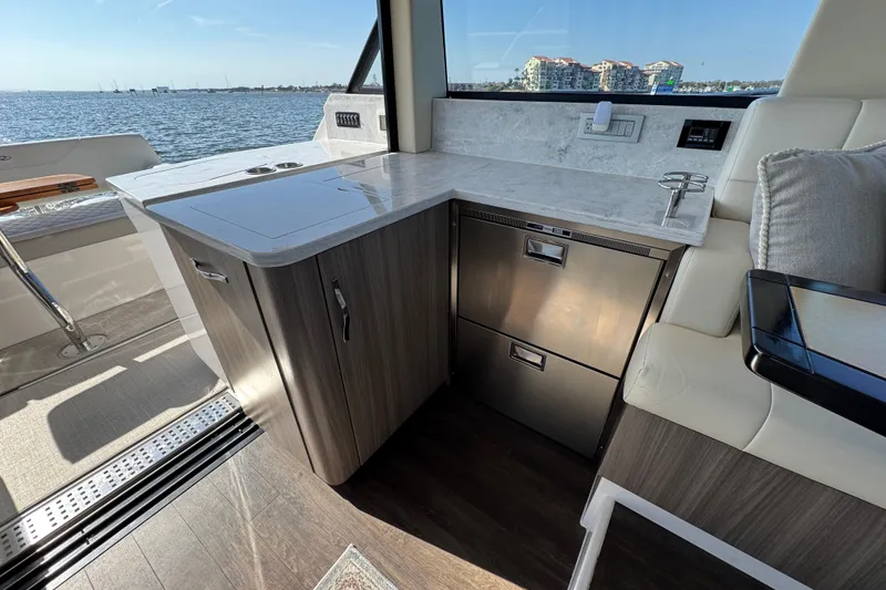 Slide: The Image of Luxurious interior of 2021 Regal 38 XO yacht with modern kitchenette and waterfront view. - 44