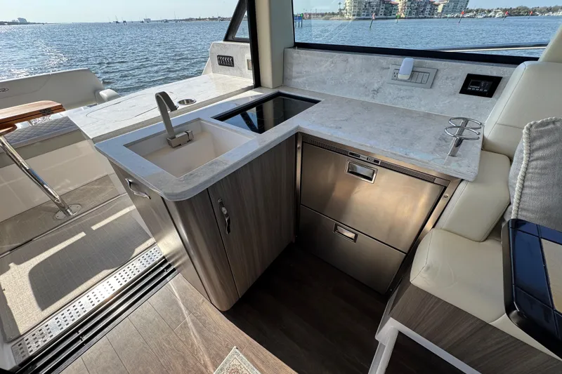 Slide: The Image of Luxurious 2021 Regal 38 XO yacht interior with modern kitchenette and scenic ocean view. - 45