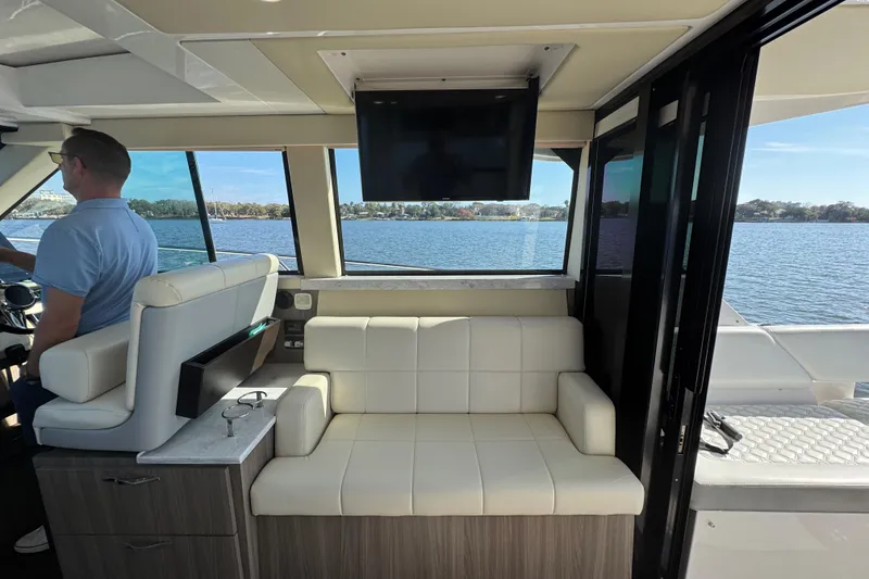 Slide: The Image of Interior of 2021 Regal 38 XO yacht with seating and water view. - 51