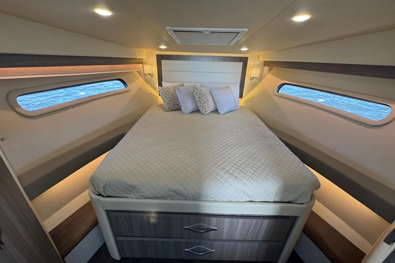 Slide: The Image of Luxurious cabin interior of 2021 Regal 38 XO yacht with cozy bed and ambient lighting. - 55