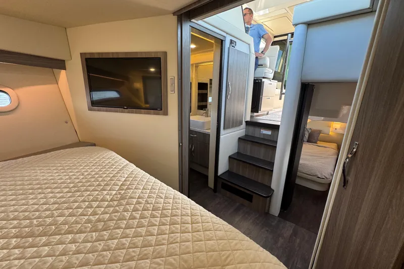 Slide: The Image of Luxurious interior of 2021 Regal 38 XO yacht featuring cozy bedrooms and modern amenities. - 56