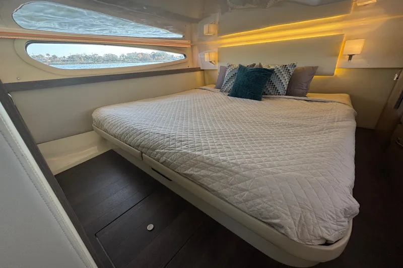 Slide: The Image of Luxurious bedroom interior of 2021 Regal 38 XO yacht with elegant bedding and ambient lighting. - 60