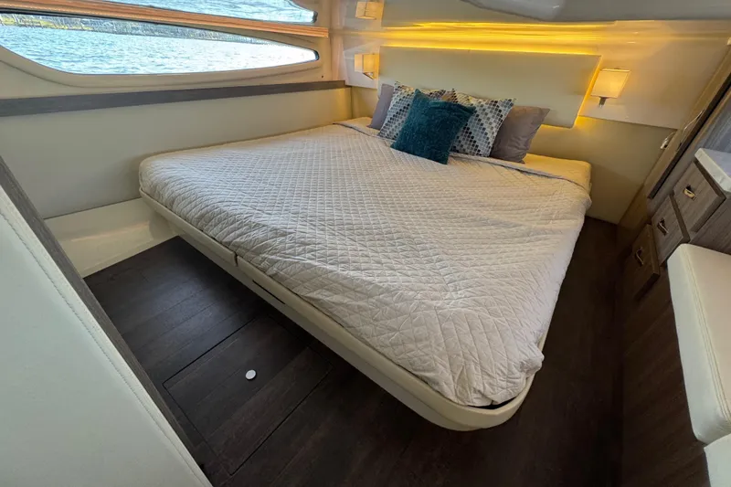 Slide: The Image of Luxurious cabin interior of 2021 Regal 38 XO yacht with cozy bed and elegant decor. - 64