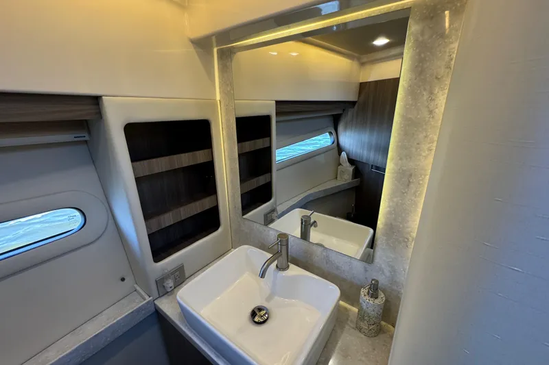 Slide: The Image of Luxurious bathroom interior of 2021 Regal 38 XO yacht with modern sink and mirror. - 66