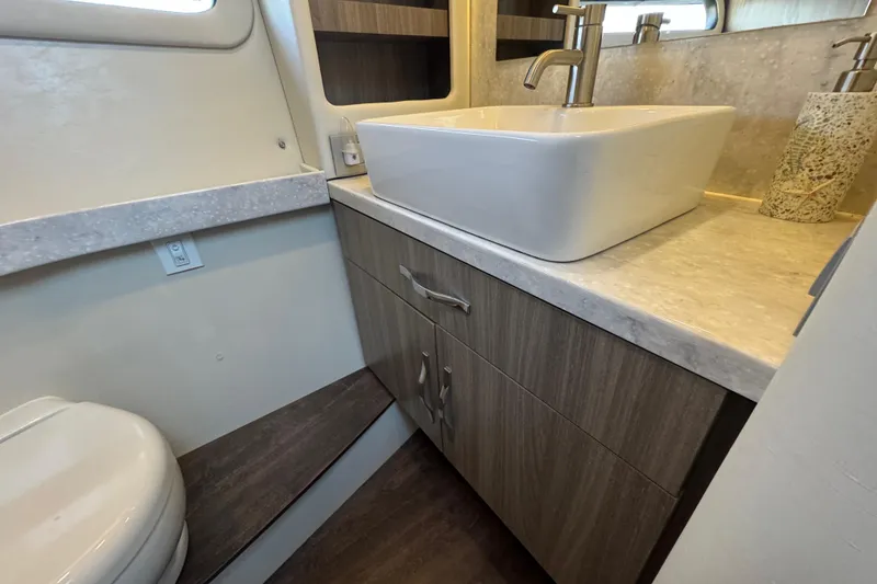 Slide: The Image of 2021 Regal 38 XO yacht bathroom with modern sink and wooden cabinetry. - 67