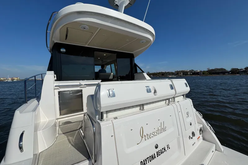Slide: The Image of 2021 Regal 38 XO yacht named "Irresistible" docked at Daytona Beach, FL. - 70