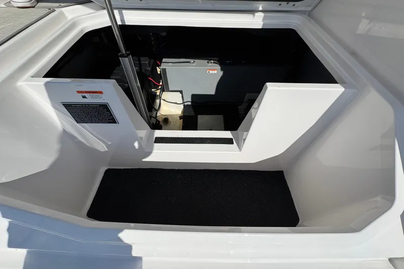 Slide: The Image of 2021 Regal 38 XO boat storage compartment with open hatch and visible equipment. - 72