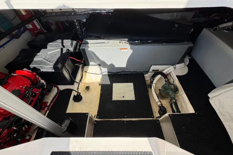 Slide: The Image of Engine compartment of 2021 Regal 38 XO boat, showcasing mechanical components and wiring. - 73