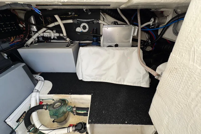 Slide: The Image of Engine compartment of a 2021 Regal 38 XO boat, showcasing mechanical components and wiring. - 74