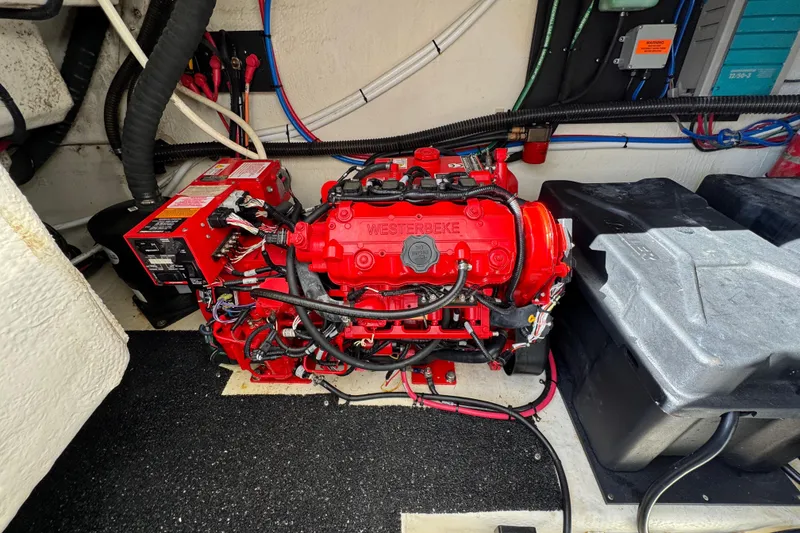 Slide: The Image of Engine compartment of 2021 Regal 38 XO with red Westerbeke generator. - 75