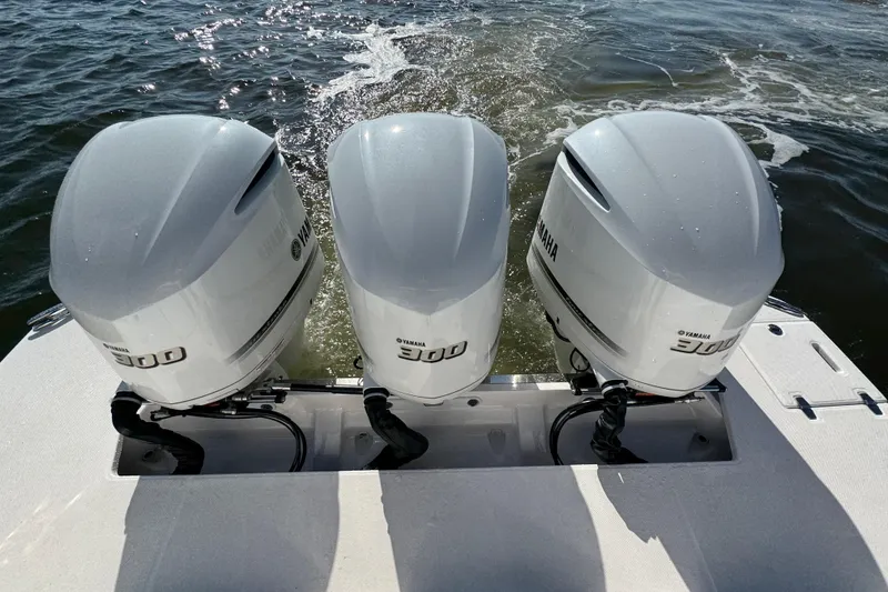 Slide: The Image of Triple Yamaha 300 outboard engines on a 2021 Regal 38 XO boat in motion. - 77