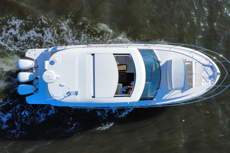 Slide: The Image of Aerial view of 2021 Regal 38 XO yacht cruising on water. - 9