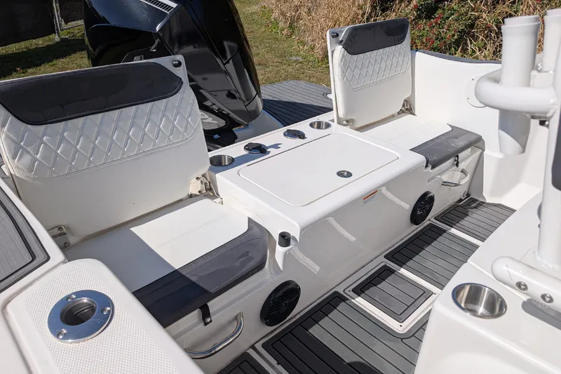 Slide: The Image of 2025 Bayliner Trophy T22CC boat interior with seating, storage, and cup holders. - 13