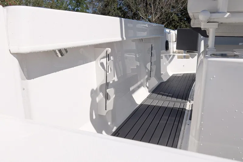 Slide: The Image of 2025 Bayliner Trophy T22CC boat interior with rod holders and non-slip flooring. - 16