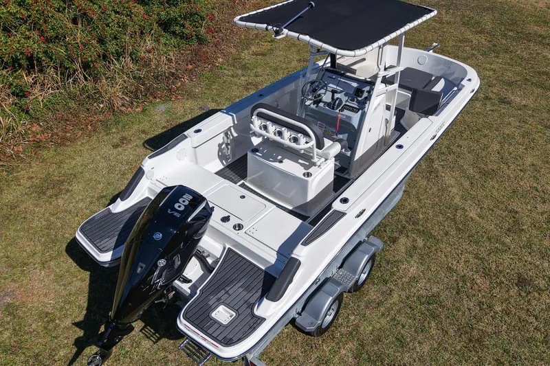 Slide: The Image of 2025 Bayliner Trophy T22CC boat on trailer, featuring sleek design and powerful outboard motor. - 2