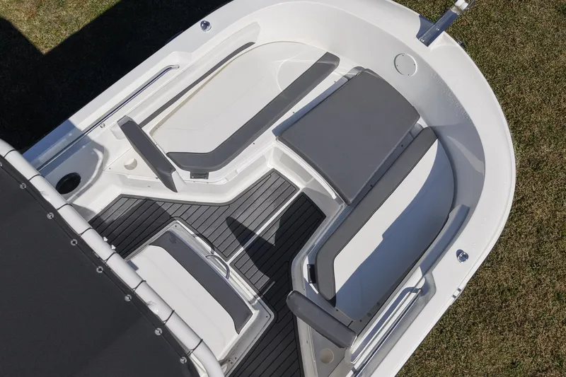 Slide: The Image of 2025 Bayliner Trophy T22CC boat interior with cushioned seating and sleek design. - 9